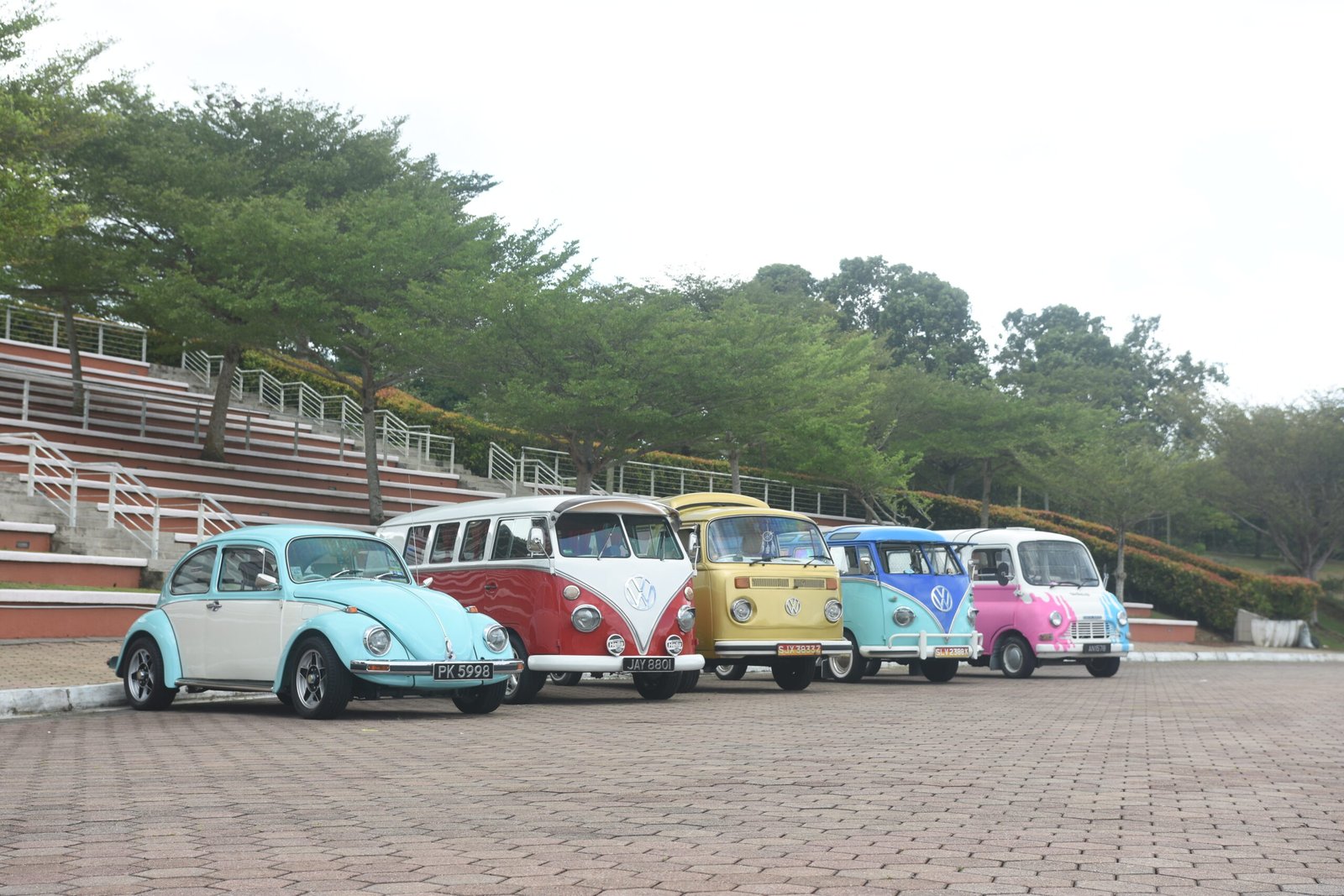 Row of vintage VW Beetle and Kombi vans for event displays in Singapore